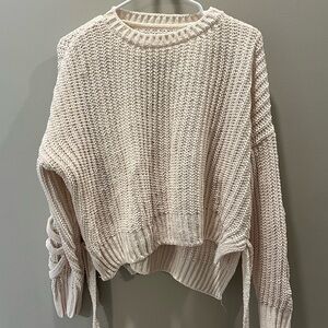 Knit sweater with braided sleeves
